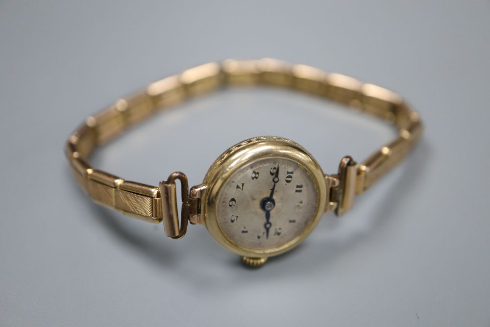 A ladys 9ct gold manual wind wrist watch, on a gold plated bracelet,